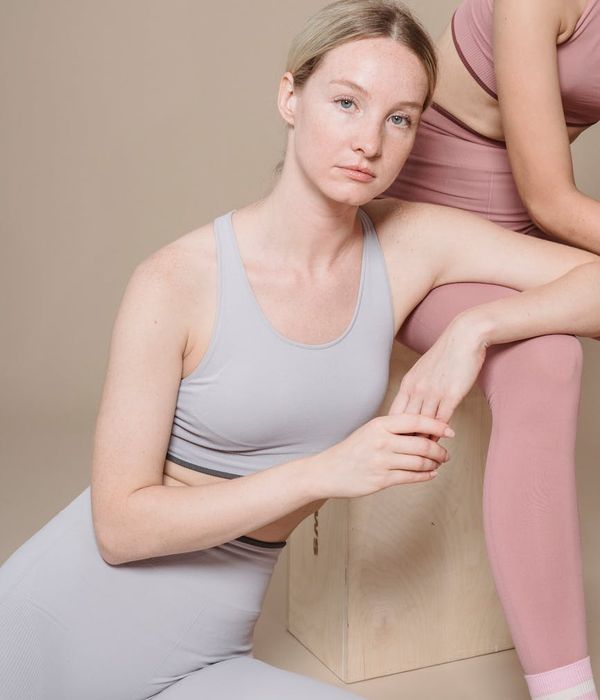 A strong pregnant woman holding a yoga pose, looking confident and calm.